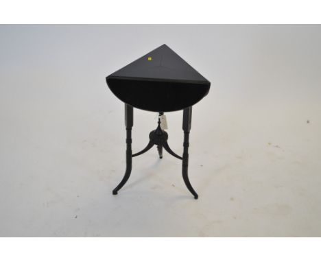 A 20th Century ebonised occasional table, the triangular to with three drop flaps, raised on tuned and outswept legs united w