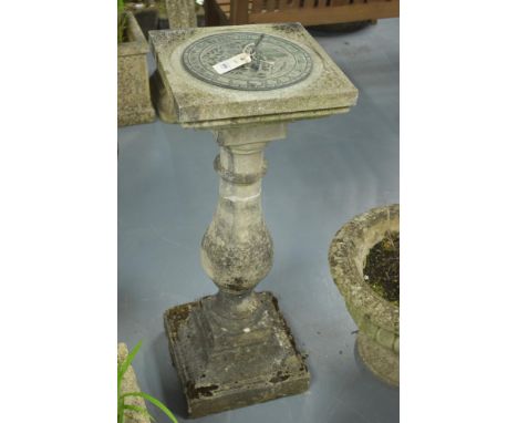 A stone composite garden sundial finished in brass, 88cms high.