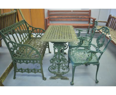 A wrought iron green painted rectangular garden table; a garden bench; and two armchairs.