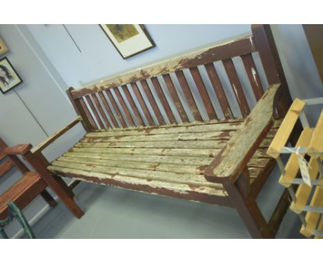 A large rustic garden bench, probably teak, 195cms wide.