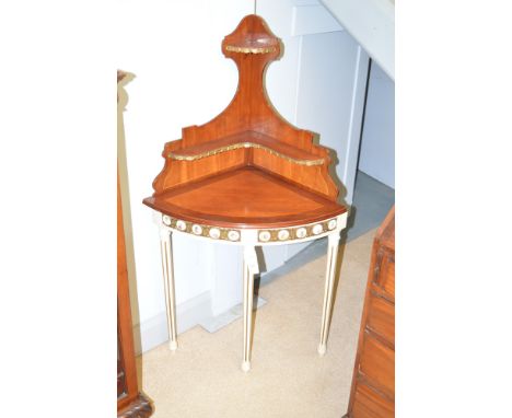 A 20th Century French style mahogany and cream painted corner table, the raised superstructure with two shelves above a cream