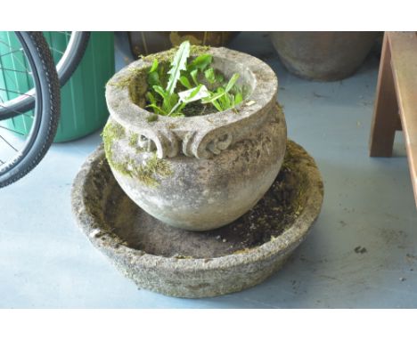 A stone composite garden urn; together with a composite circular trough.