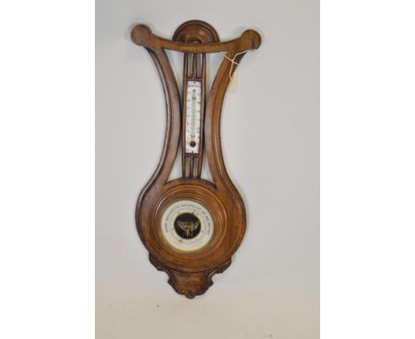 An early 20th Century rosewood barometer of lyre-form. 62cms high