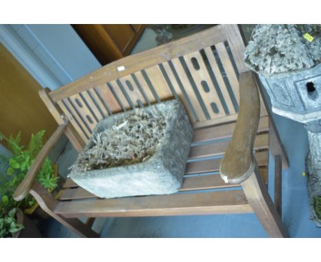 A modern stained teak garden bench, 130cms wide.