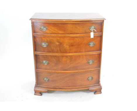 A 20th Century Chapman mahogany bowfront chest of drawers with moulded top above an arrangement of four long drawers raised o