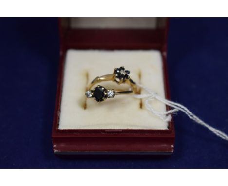 Two sapphire and diamond rings, one cluster; the other three stone, both on 9ct. yellow gold shanks, ring size N.