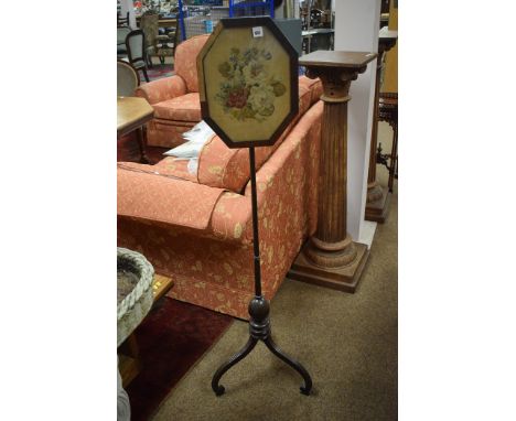 A 19th Century pole screen, the octagonal face screen with tapestry panel (veneer missing from edges of screen), raised on a 
