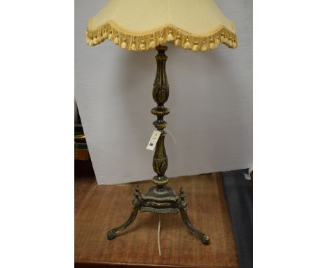 An antique style table lamp with cream coloured shade.