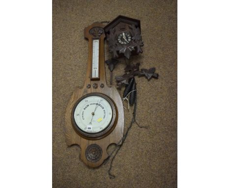 An early 20th Century oak barometer, by A.Wares Ltd. South Shields; together with a Black Forrest Style cuckoo clock.