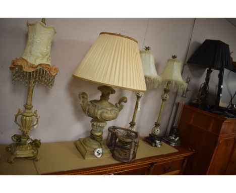 A cast metal table lamp with white marble base; and five other modern table lamps of various designs, some with shades.