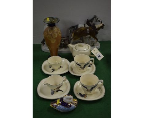 A Royal Crown Derby paperweight of a duck, with gold stopper; and a Royal Doulton vase with floral decoration on textured gro