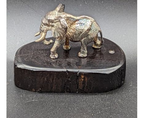 A Patrick Mavros silver sculpture of an elephant, raised on hardwood base, Zimbabwe 1990s, designerâ€™s silver monogram to ba