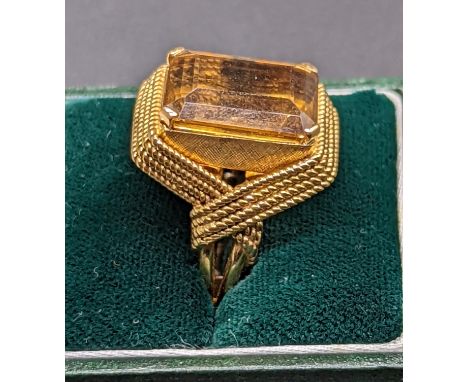 An 18ct gold and citrine ring, rope style mount, indistinct mark, stone size 1.5cm x 1.3cm, 15g, current size M