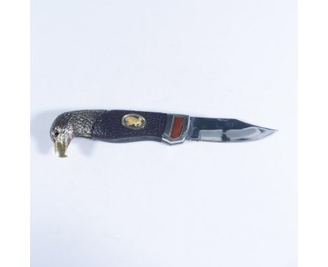 This exquisite folding pocketknife features an eagle head design by Ray Beers with a silver-plated bolster and hammered-textu