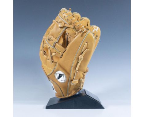 Unused, 4183 glove made of pro tanned cowhide and autographed on the pinky in silver sharpie. This item has a plastic base wi