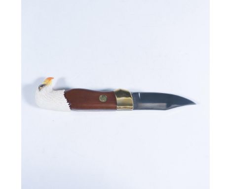 This exquisite folding pocketknife features an eagle head design by Ray Beers with a 24k gold-plated bolster, natural wood sc