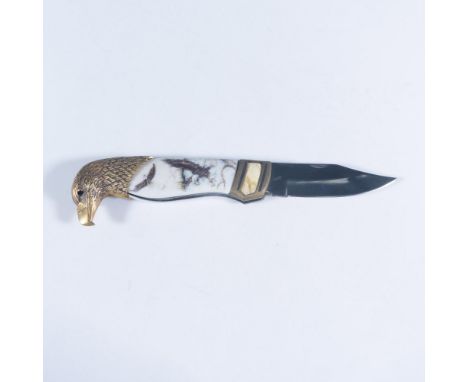 This patriotic folding pocketknife features an eagle head design by Ray Beers with brass bolster and scales featuring eagles 