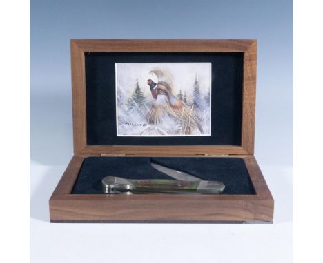 Lockback folding hunters in custom walnut display boxes. Stainless clip blade with pheasant etch. Polished wood handles with 