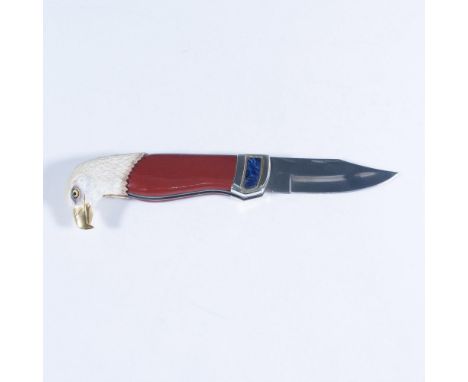 This stunning folding pocketknife features an eagle head design by Ray Beers with a silver-plated bolster, red stained wood s