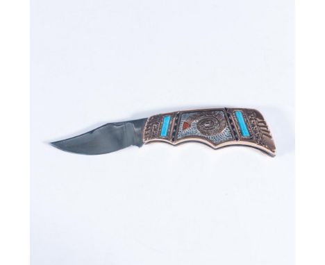 This exquisite folding pocketknife features copper and turquoise scales featuring American Indian designs with silver inlay. 