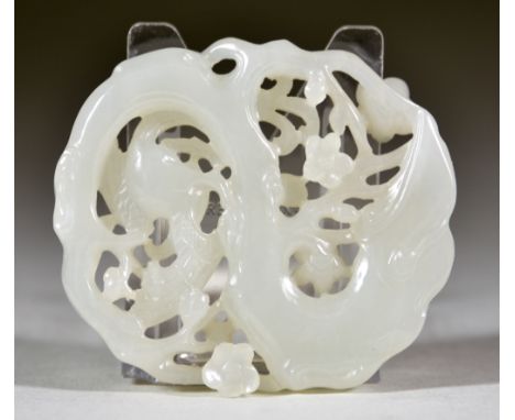 A Chinese White Jade Pendant, 19th Century, pierced and carved with a bird and flowering tree, 2ins (5.1cm) x 2.25ins (5.6cm)