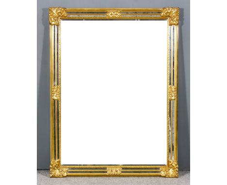 A Modern Gilt Framed Rectangular Wall Mirror, with scroll mouldings and inset with bevelled mirror panel, 46.5ins x 35ins