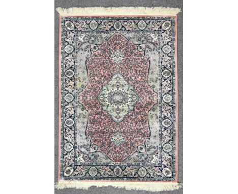 A Modern Rug of Kashan Design, woven in pastel colours with bold central stylised floral pole medallion, on a rose ground, th