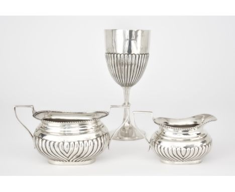 A Late Victorian Silver Goblet and an Edward VII Two-Handled Sugar Basin and Milk Jug, the goblet by James Deakin &amp; Sons,