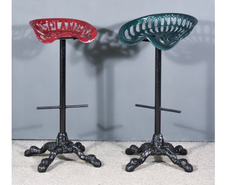 Two Early 20th Century Cast Iron Tractor Seats, now converted into bar stools, on later bases with leaf scroll ornament and s