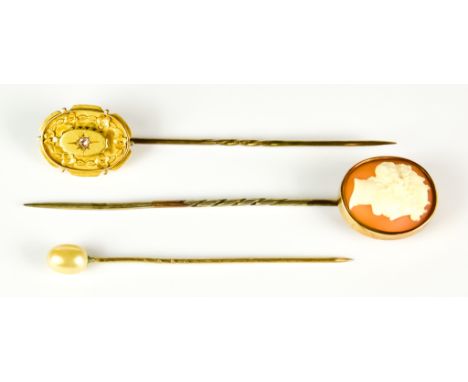 Three Stick Pins, yellow metal, one with carved cameo bust, one set with small gem stone and one topped with an oval pearl, t