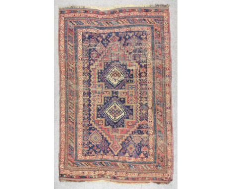 A Late 19th Century Afshar Rug, woven in colours of fawn, navy blue and wine, with a bold central stepped lozenge-shaped pole