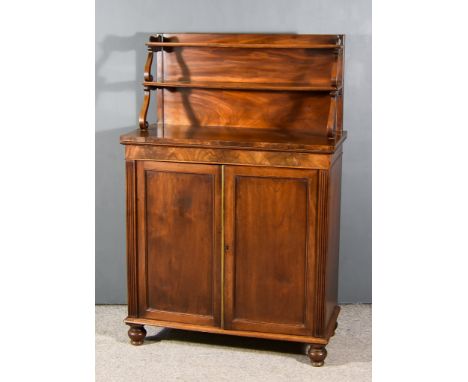 A Regency Mahogany Chiffonier, the upper part fitted two open shelves on scroll supports, the base fitted one shelf enclosed 