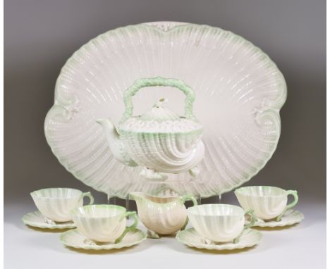 A Belleek Neptune Pattern Part Tea Service, second period, comprising - tray 17.5ins x 14ins, teapot with high strap handle a
