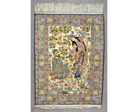 A 20th Century Isfahan Picture Rug, woven in colours of ivory, navy blue and wine, the field filled with two figures pouring 