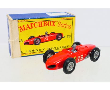 Matchbox - A boxed Matchbox Regular Wheels 73b Ferrari Formula 1 Racing Car. The model in red with RN73, grey plastic driver,