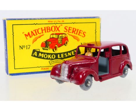 Matchbox - A boxed Matchbox Regular Wheels 17c Austin Metropolitan Taxi. The model in maroon with dark grey interior and base