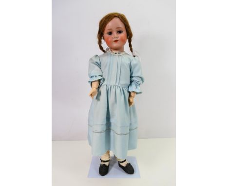 Schoenau & Hoffmeister - A Germany bisque headed doll approximately 58 cm tall and marked S PB H 1923 5 1/2 Germany on the ba