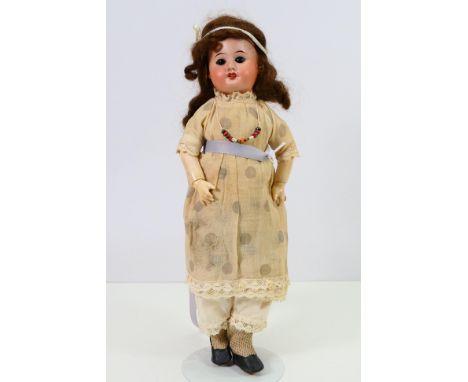 SFBJ - A French doll approximately 38 cm tall and marked SFBJ 60 Paris to the back of the head. It shows some signs of age an