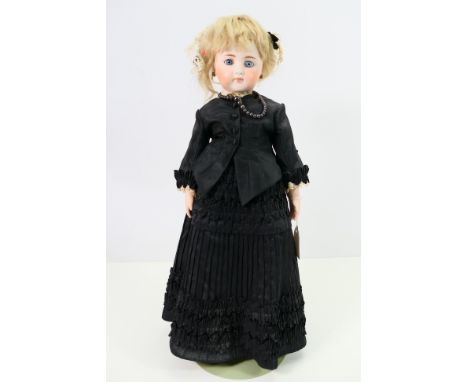 Simon & Halbig - A composite doll with bisque head, forearms and hands and porcelaine legs with black boots. The doll is appr
