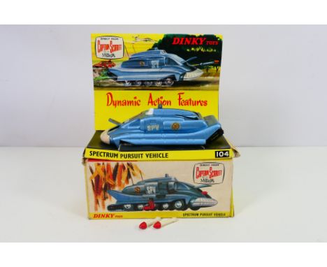 Dinky - A boxed Captain Scarlet Spectrum Pursuit Vehicle # 104. The model appears in Near Mint condition, the white rubber fr