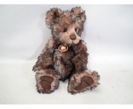 Charlie Bears - A jointed bear "Ashley" CB104683. Approx 36 cm long in two tone fur, wearing a bell studded collar. Comes wit