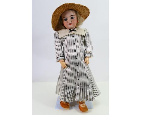 Simon & Halbig - A large bisque headed doll marked SH 1099 8 1/2 DEP on the back of the head. The doll is approximately 52 cm