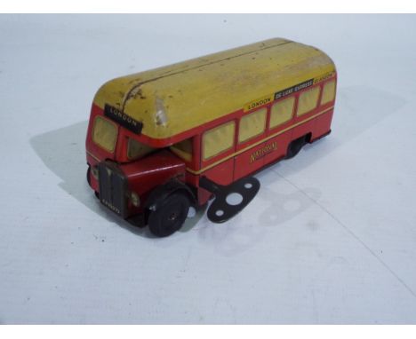 Chad Valley - A rare 1950s clockwork pressed metal London to Glasgow bus in National red livery. It measures approximately 15