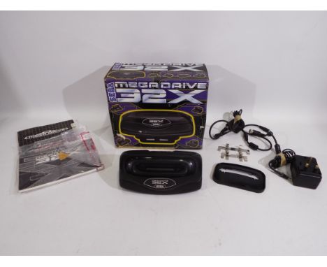 Sega - A boxed Mega Drive 32X console - Box appears in fair condition with some storage wear. Lot comes with instruction manu