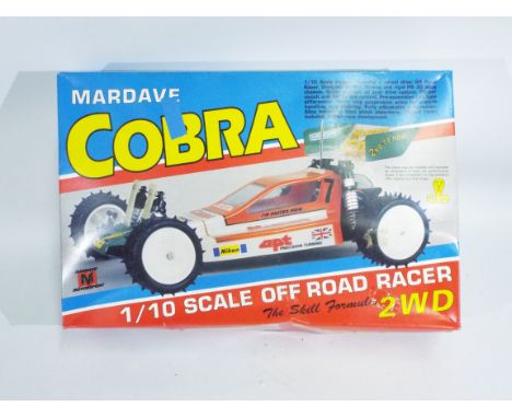 Mardave, Tamiya - A boxed 1/10 scale Mardave Cobra Off Road R/C racer car. R/C racer appears in good condition with grazing t