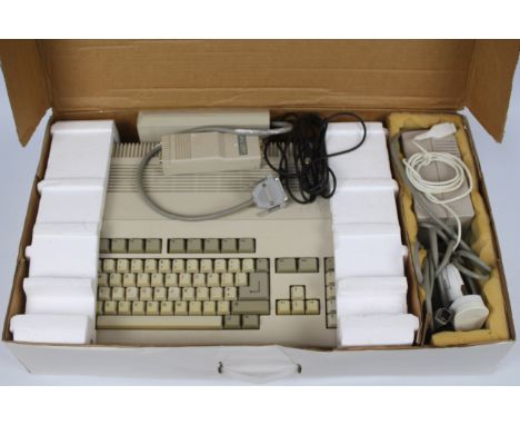Commodore - Amiga 500. A boxed Commodore Amiga 500 with A520 adapter, power transformer, external disk drive and mouse. No bo