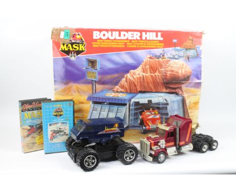 MASK - Kenner - A selection of 2 unboxed vehicles with figures with 2 VHS tapes, housed in an empty Boulder Hill box which is