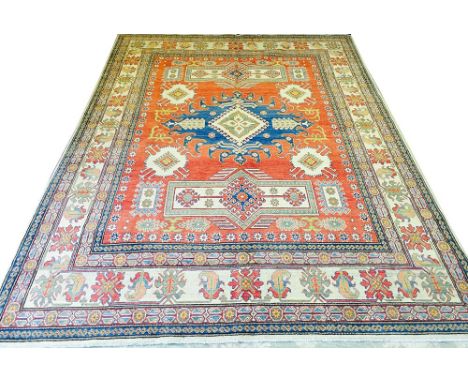 FINE KAZAK CARPET, 310cm x 223cm, stylised organic medallions on a ruby field within multiple complimentary bands and borders