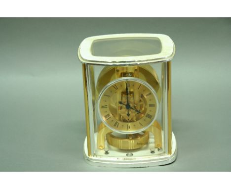 A JAEGER LE COULTRE ATMOS MANTEL CLOCK with gilded and silvered chapter ring in similar brass and glazed case no. 557392 8.75