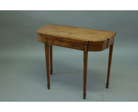 A GEORGE III MAHOGANY CARD TABLE with shaped top with mahogany and tulipwood cross banding on square tapering legs 35.5" (90 